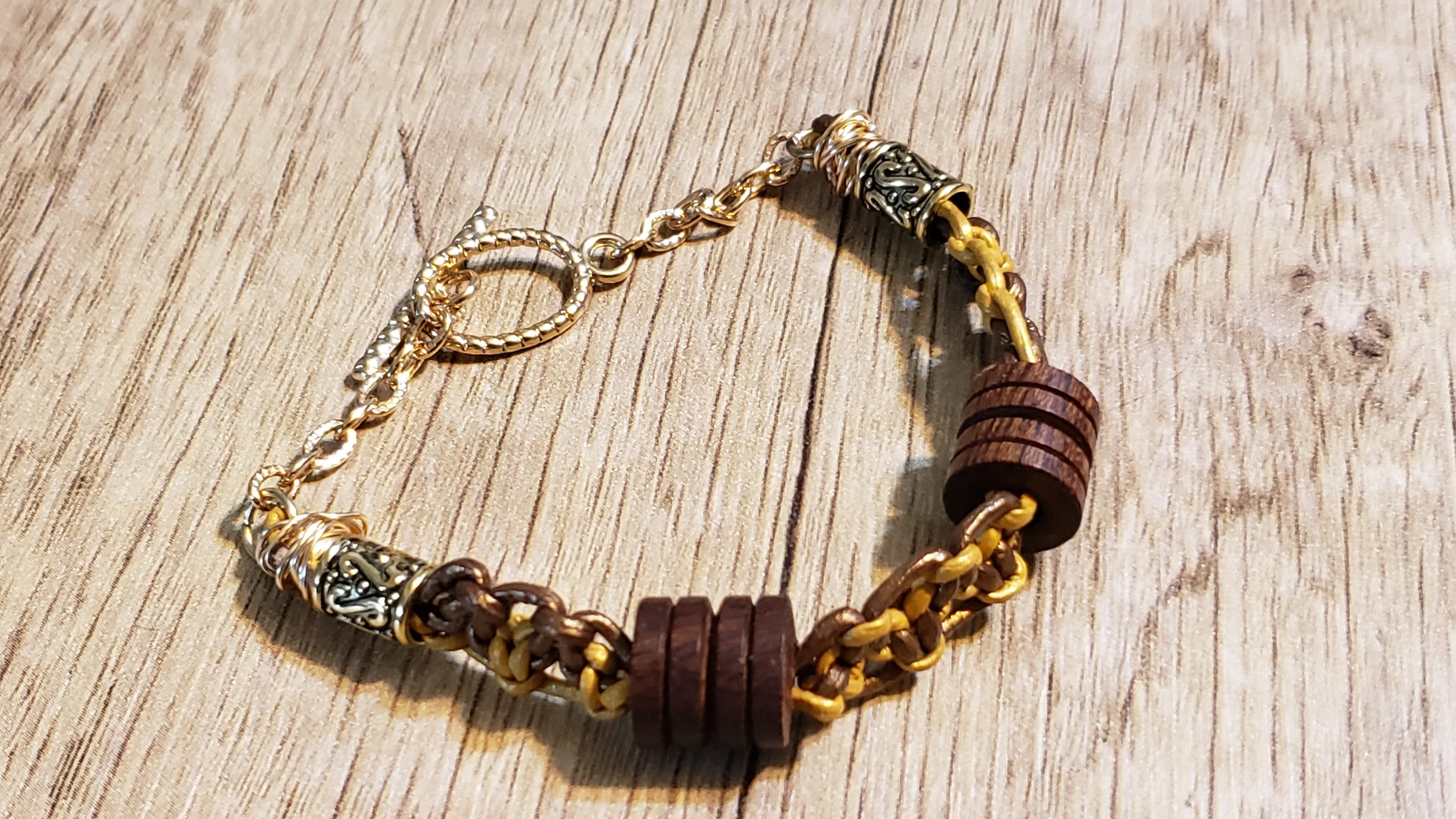 Genuine Leather Bracelet with Wood Beads & Non Tarnish Gold Tone Chain, 7.5" with Toggle Clasp.
 