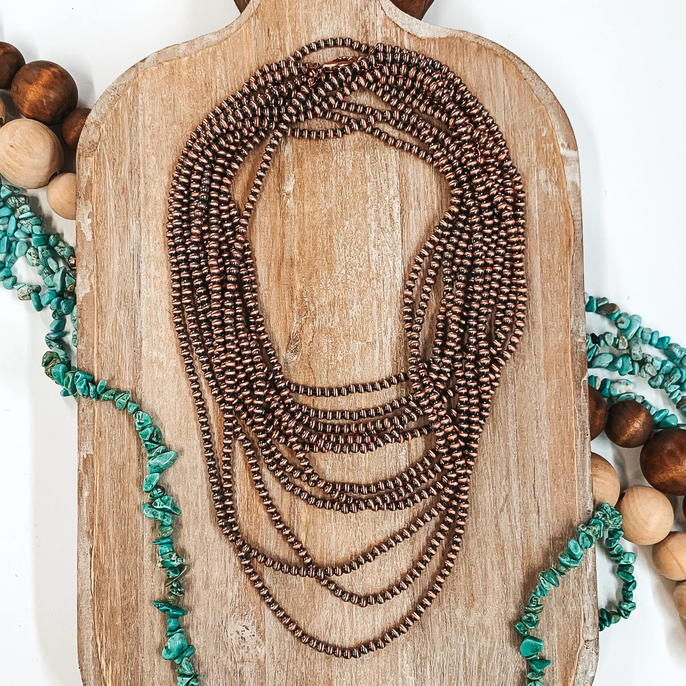 Three Strands of Long Faux Navajo Pearls in Copper Tone